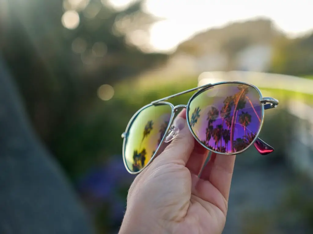 Person Holding Silver Framed polarized Sunglasses

