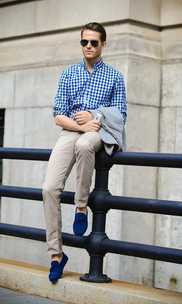 A blue patterned shirt, paired with a pair of brown khaki pants and blue loafers. Summer office wear for men