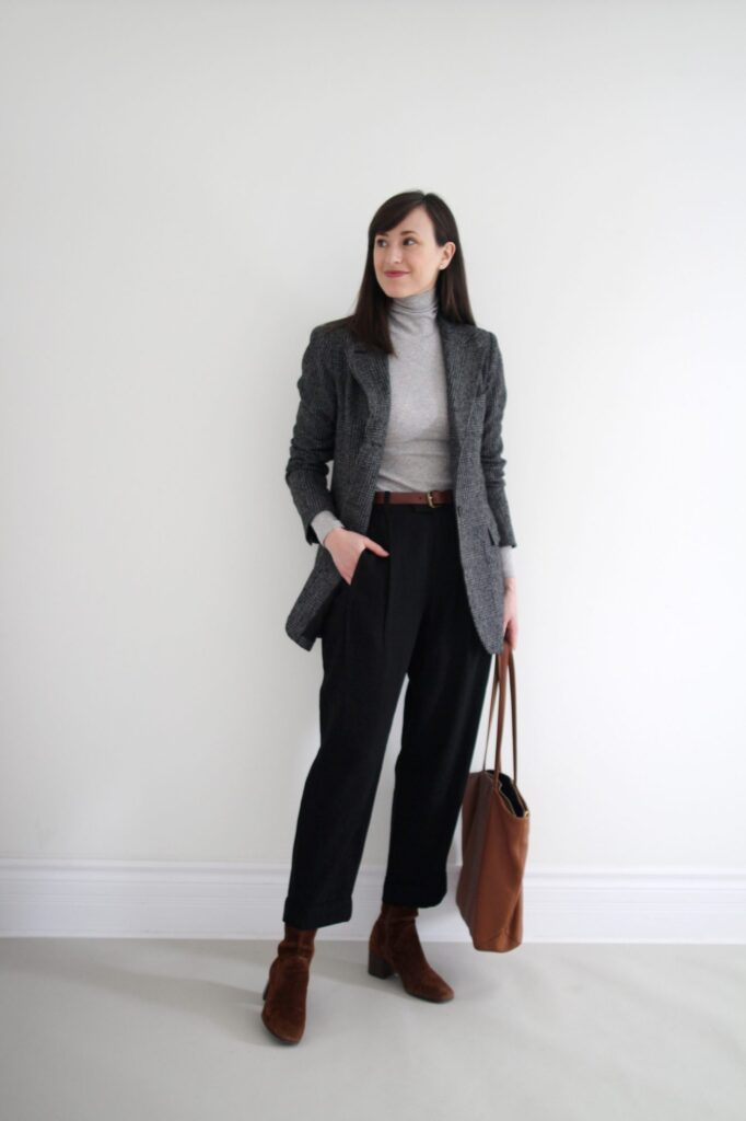 winter office wear for women, Brown leather boots, black wide-leg pants, brown leather belt, grey turtle neck sweater and navy coat