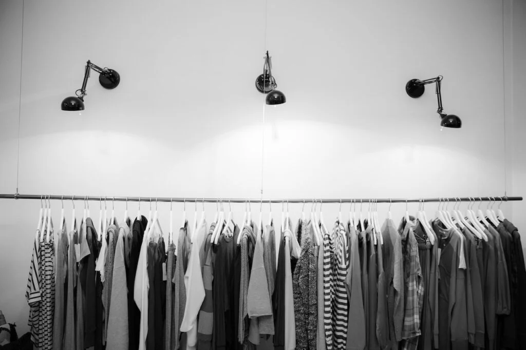 A picture of clothing in a store, to signify a clothing business